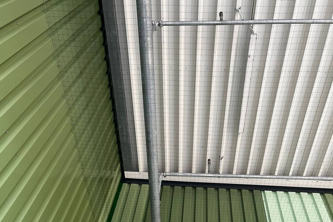 Taubenabwehr Hallendach: Taubenschutznetz unter dem Hallendach einer Industriehalle